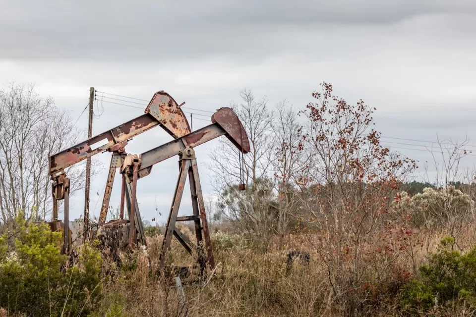 Two rusty, abandoned oil pumps in rural Texas.